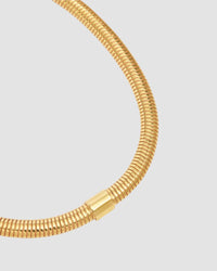 a closeup of a gold snake chain