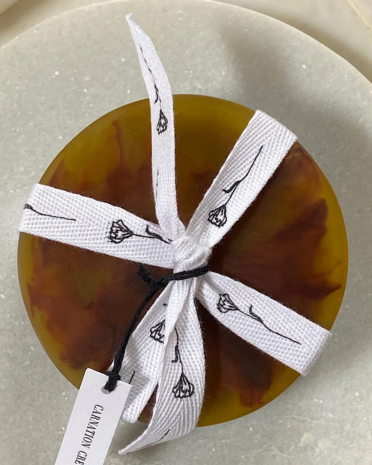 set of 4 amber coloured resin coasters tied up with ribbon