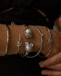 model wear a selection of silver bangles