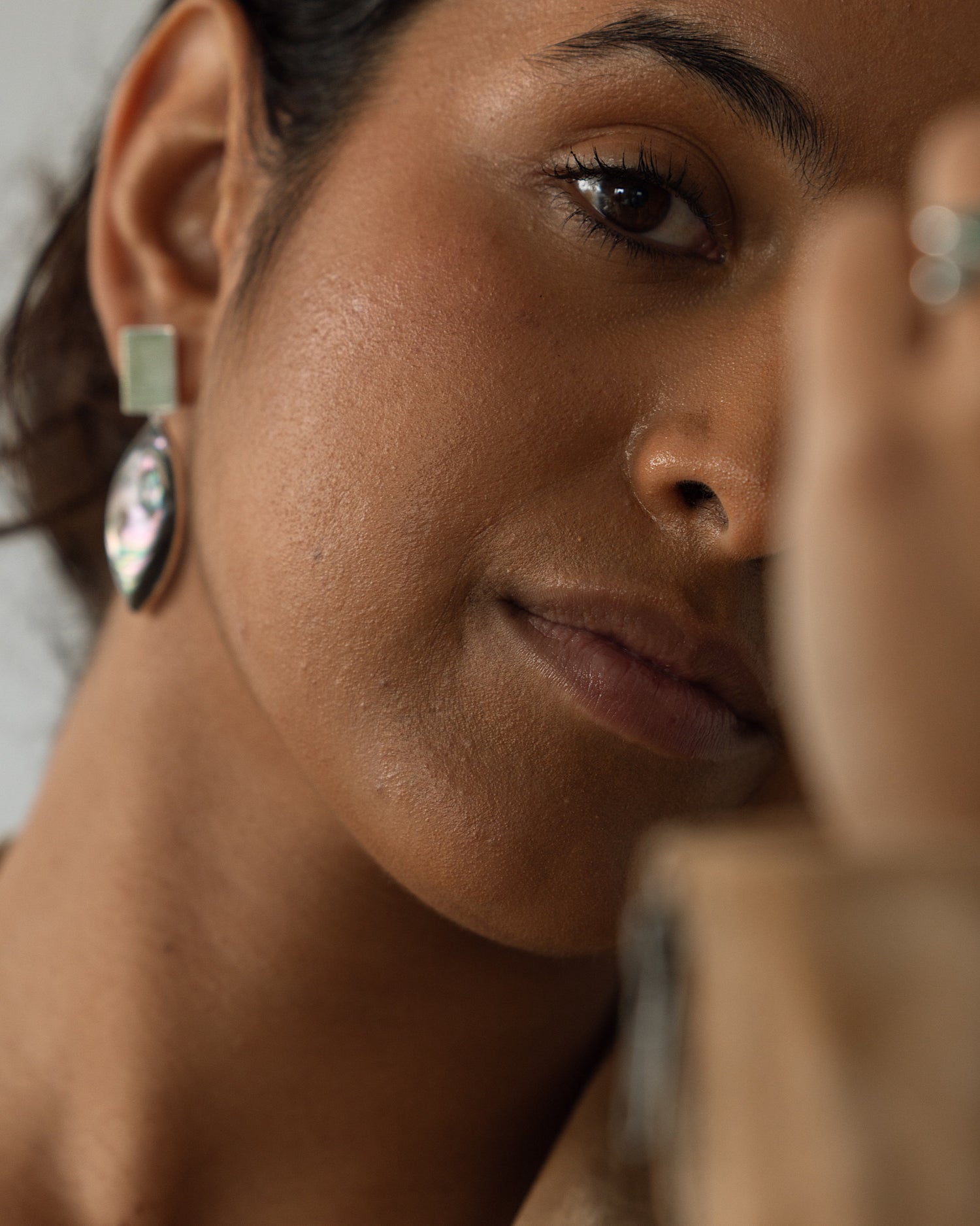 model wears an abalone earring