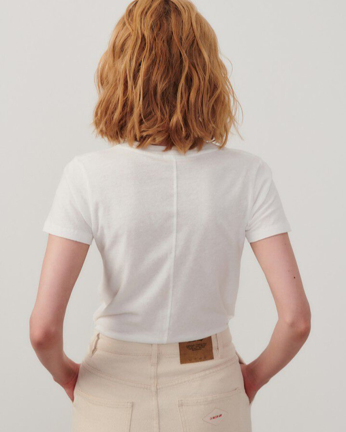 Model wears a white gampiy tshirt showing the back seam detail