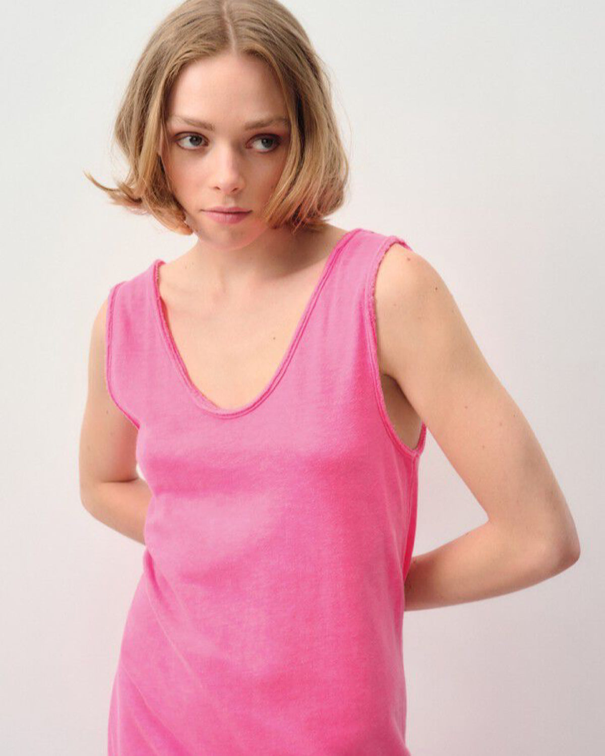 Model wears a fluro pink tank style dress with a raw edge neckline from American VIntage at The Pared Store, Australia