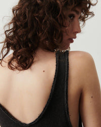 Back view of a model wearing a charcoal tank dress in Sonoma Cotton raw edge fabrication from The Pared Store