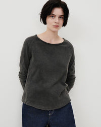 model wears a washed out black long sleeve t-shirt by American Vintage