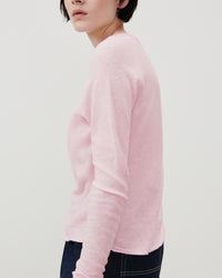 model wears a soft marshmallow pink boat neck t-shirt