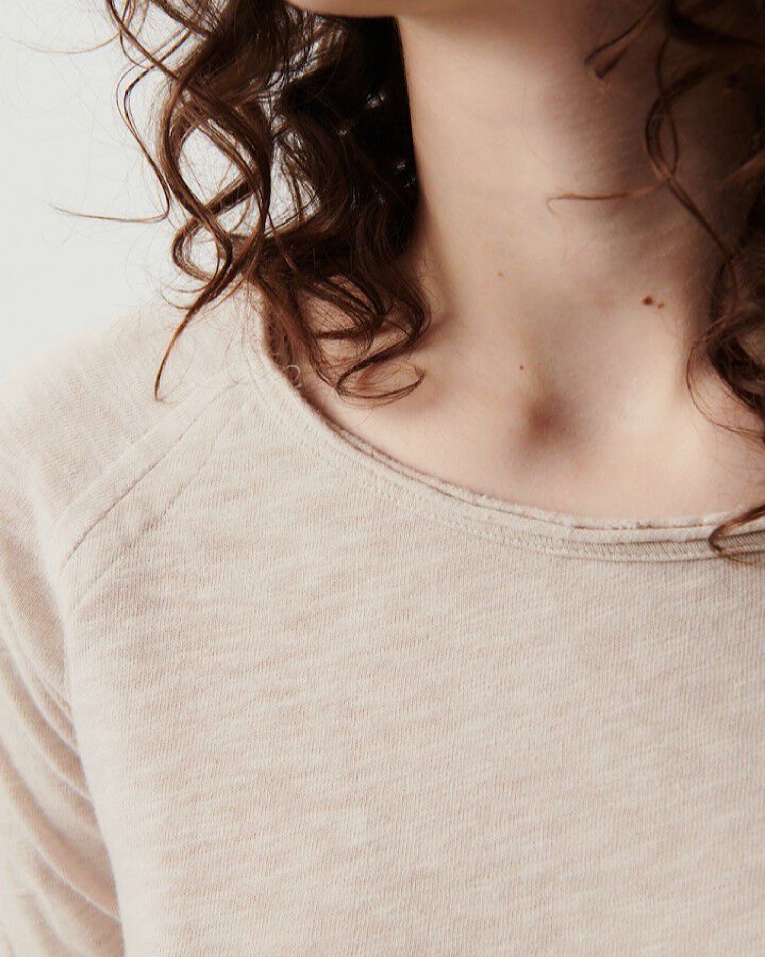 Detail of model wearing a beige mastic sonoma T-shirt from American Vintage at The pared Store, Sydney