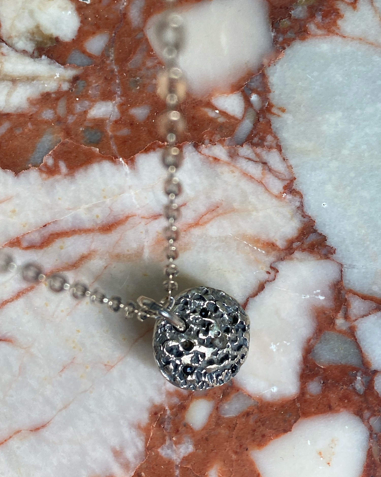 Silver and Crystal textured disc on a chain