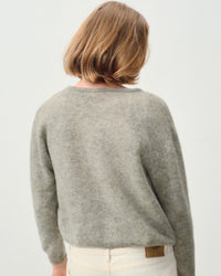 the back view of a model wearing a grey cardigan