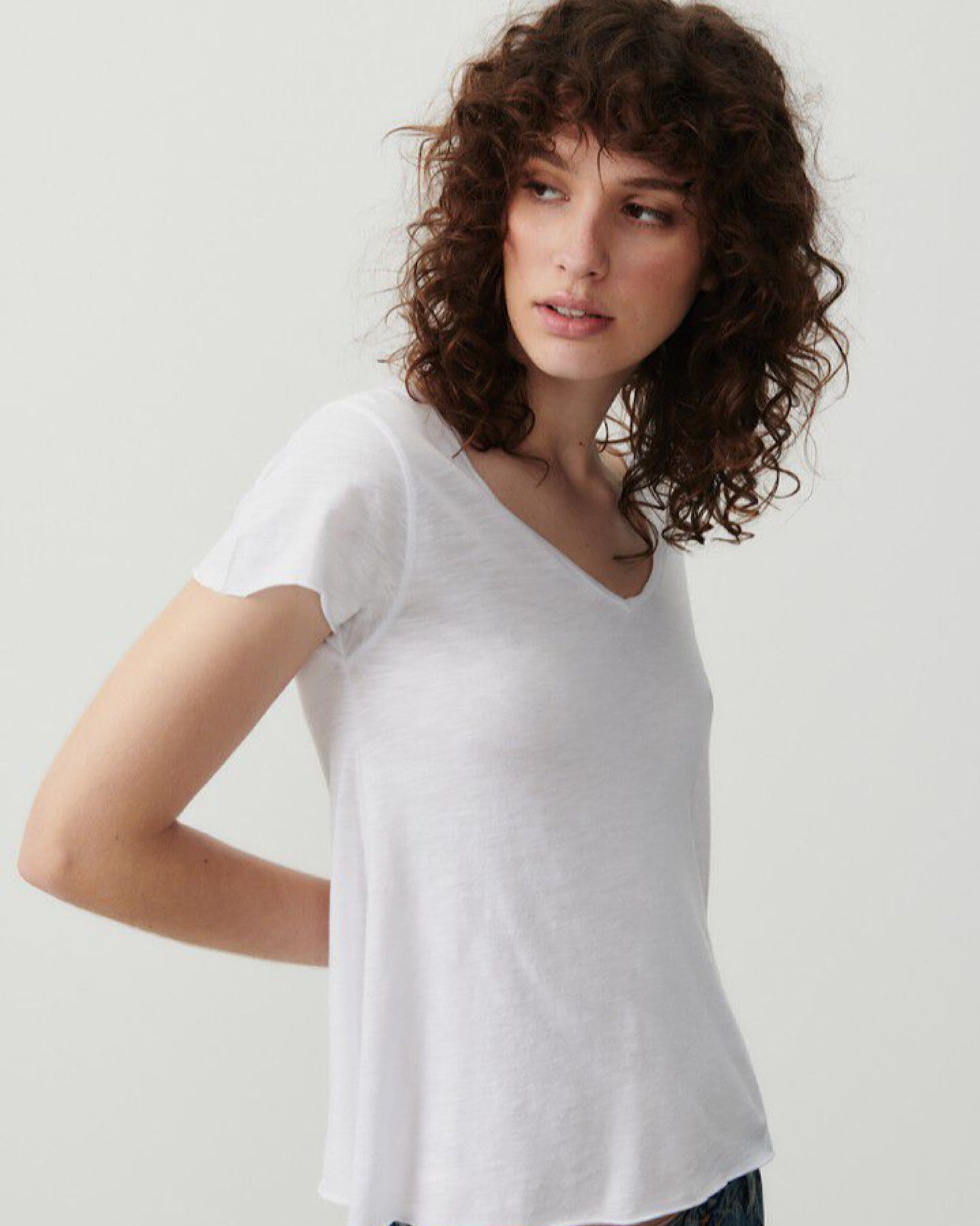 a model wears a white v short sleeve tshirt