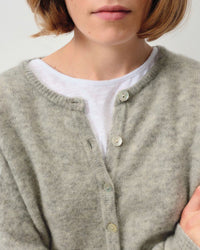 close up of a model wearing a grey cardigan with a white Tshirt