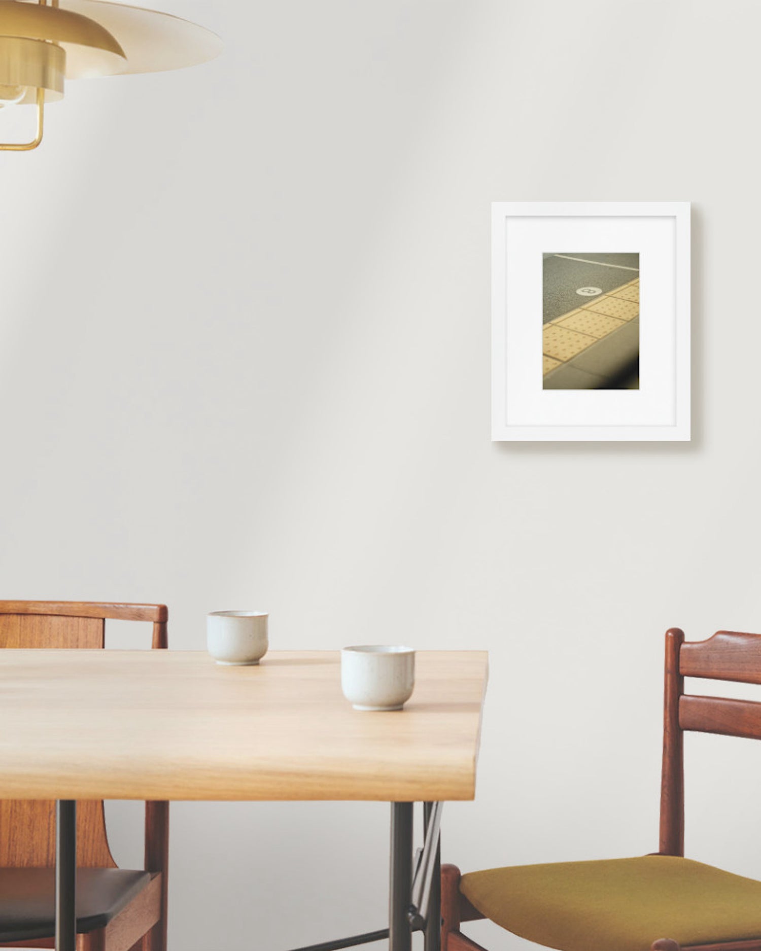 Dining area with a wooden table, chairs, and a framed picture on the wall.