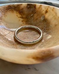 round tube like silver bangle sits in a bowl