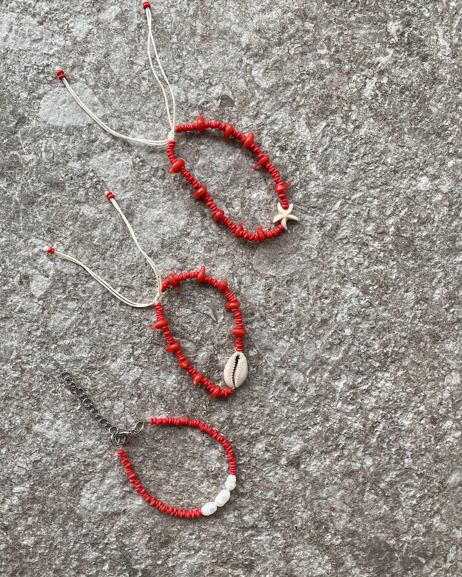 set 3 red bead bracelets with pearl or cream charm attached