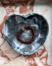 chocolate beaded bracelet with a central dark brown mottled feature bead in a heart bowl