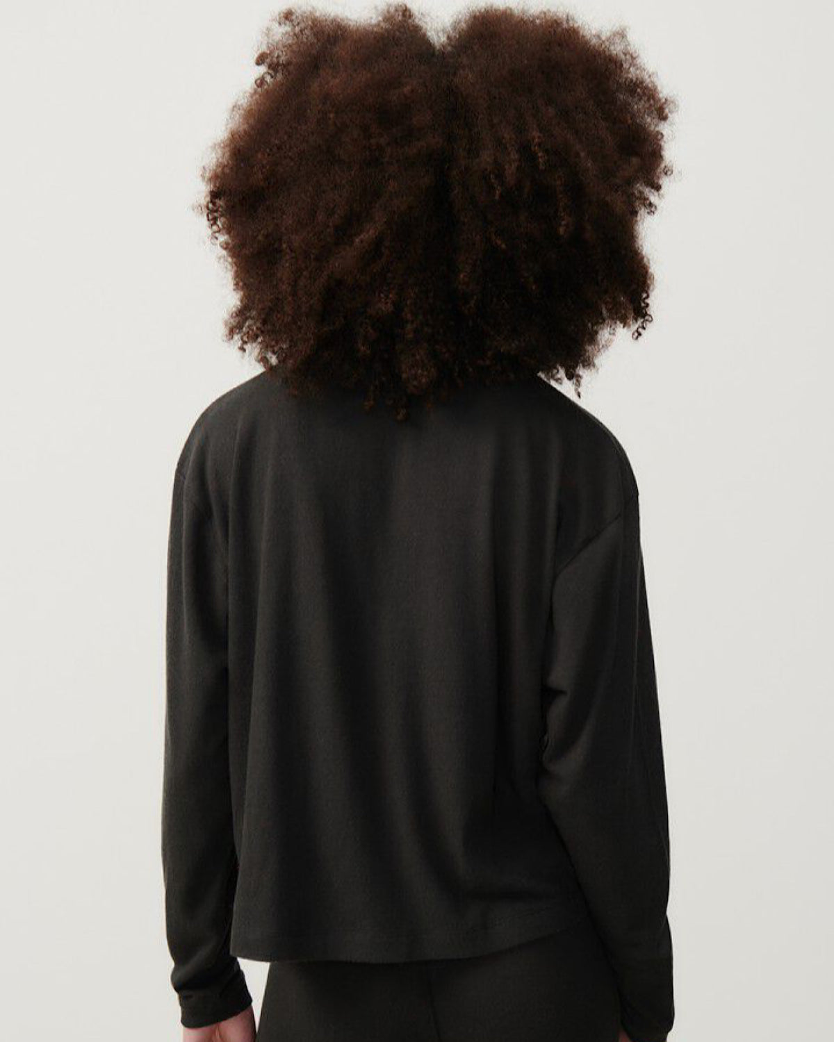 a model wears a dark grey oversized soft sweater