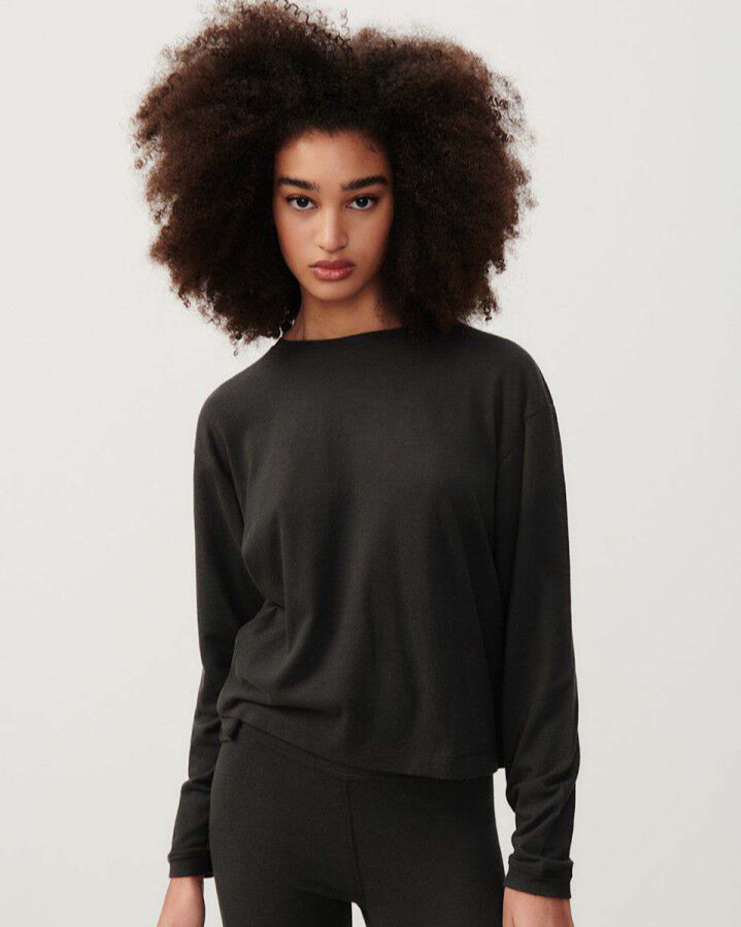 a model wears a dark grey oversized soft sweater