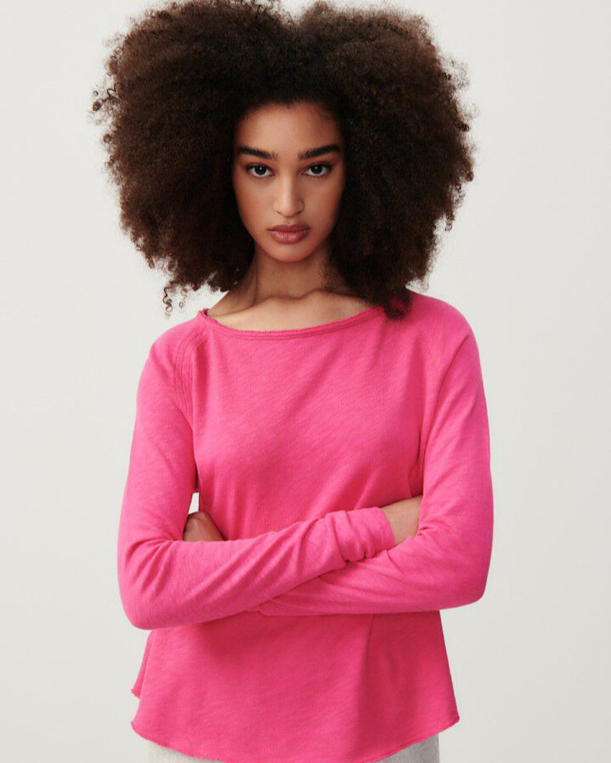 model wears a hot pink coloured boat neck long sleeve T-shirt