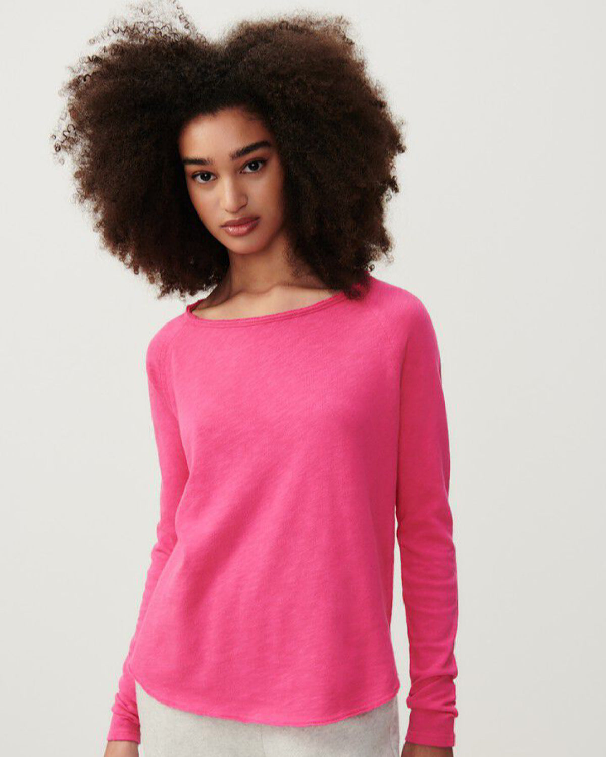 model wears a hot pink coloured boat neck long sleeve T-shirt