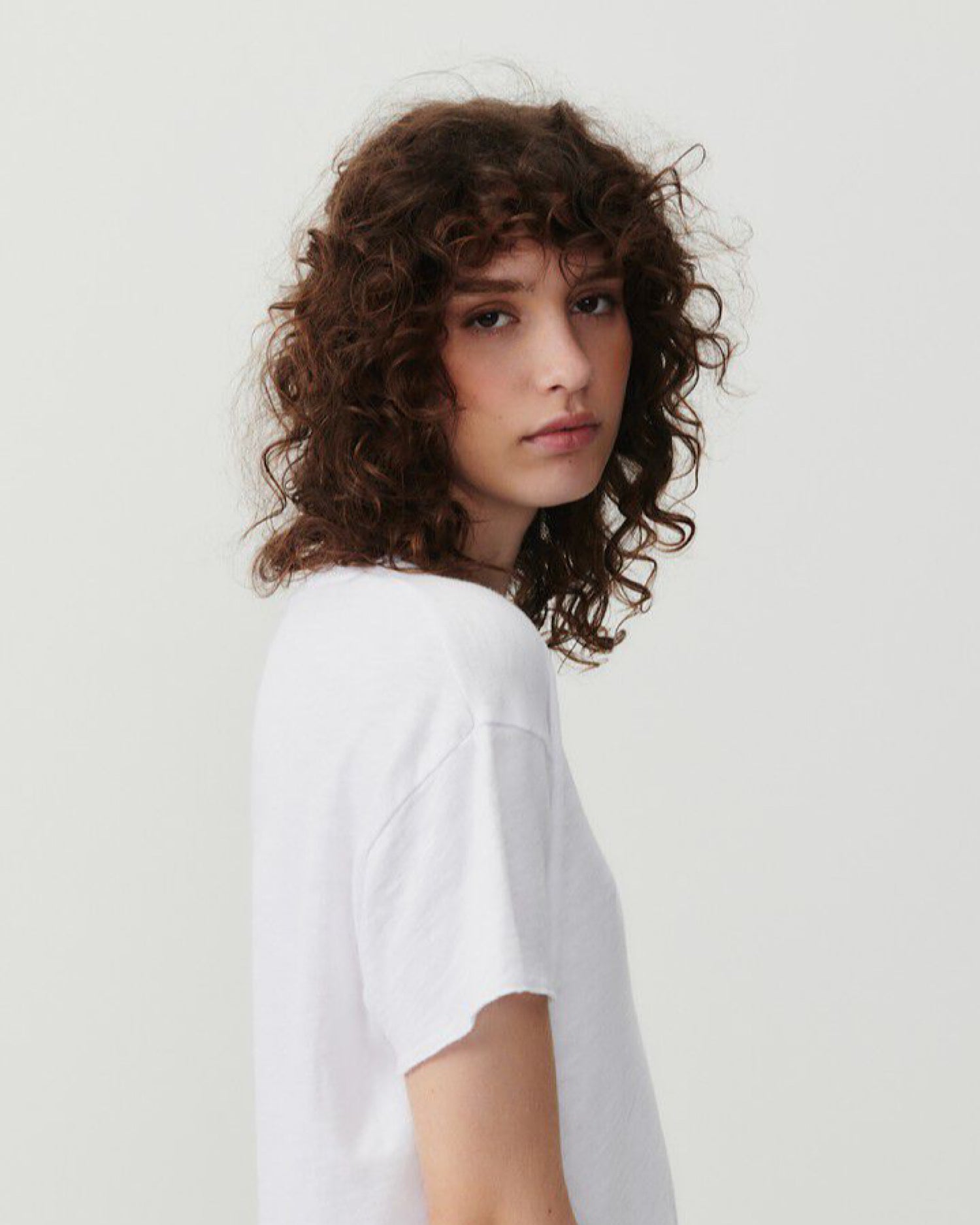 model wears a dropped shoulder short sleeved white T-Shirt