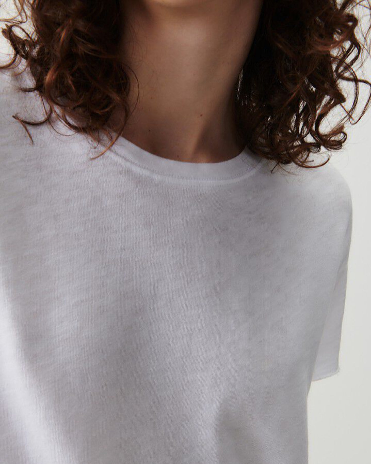 model wears a dropped shoulder short sleeved white T-Shirt