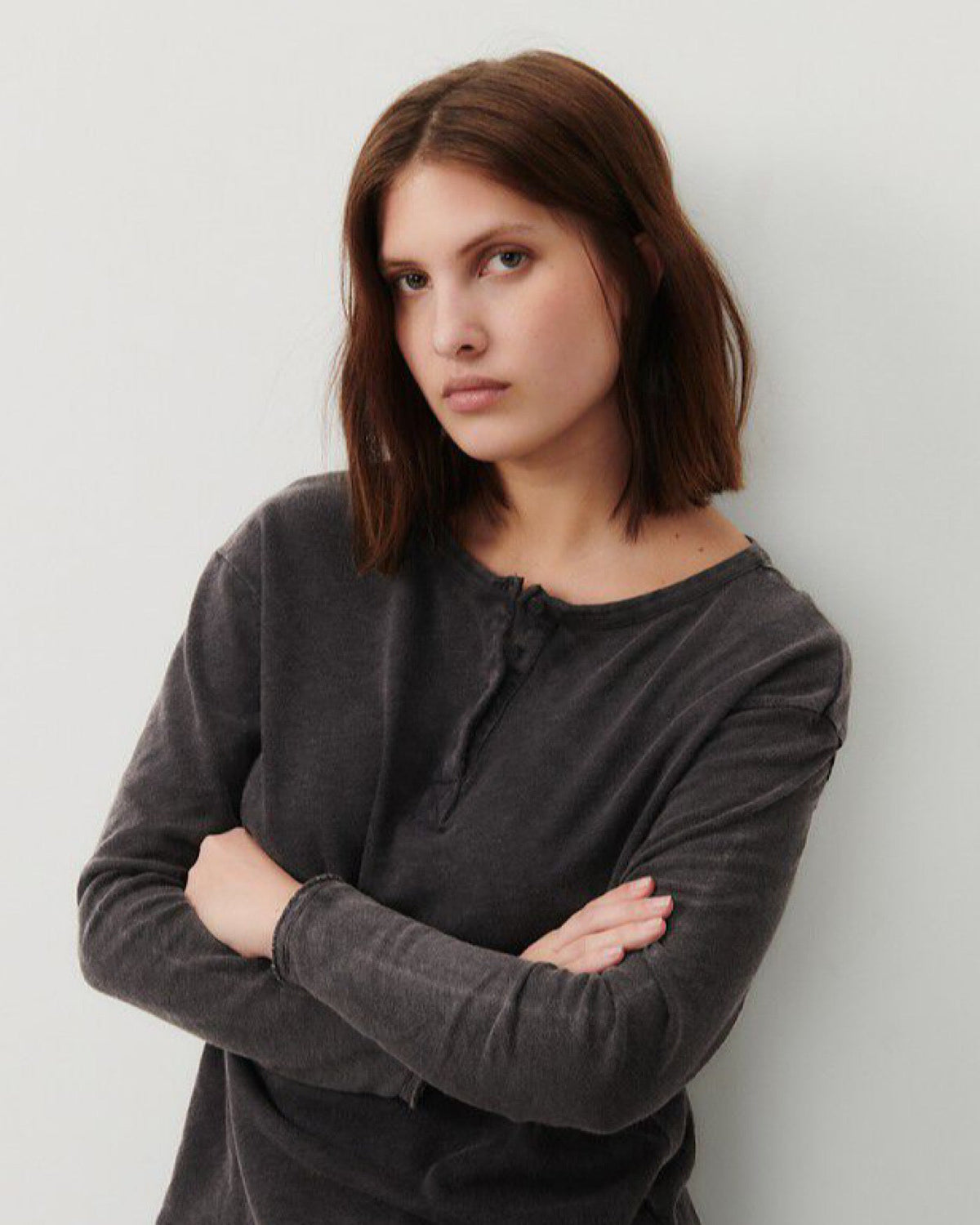 model wears a black cotton henley from American vintage