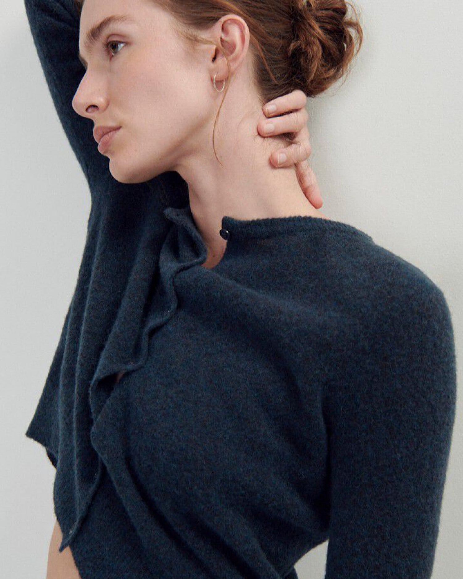 Model wears a dark blue round neck cropped long sleeve cardigan