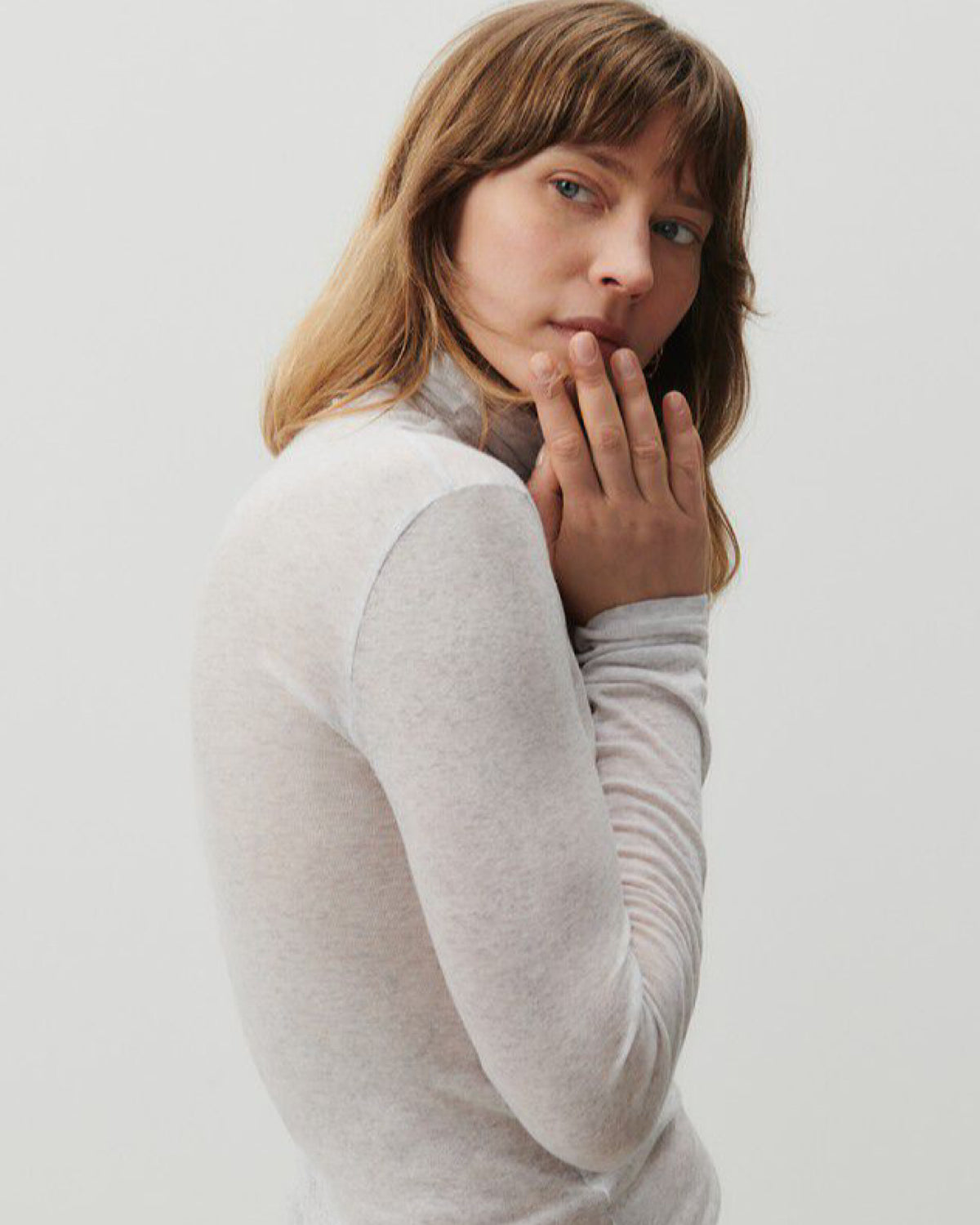 A grey mottled turtleneck on a model