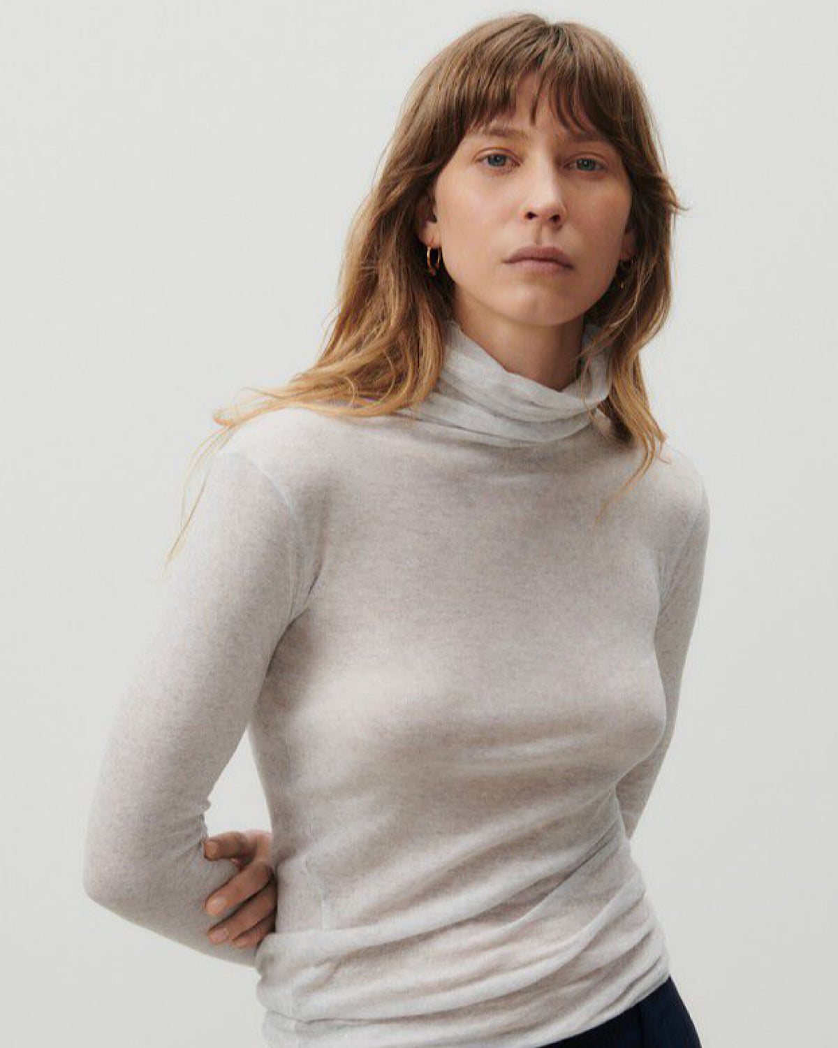 A grey mottled turtleneck on a model