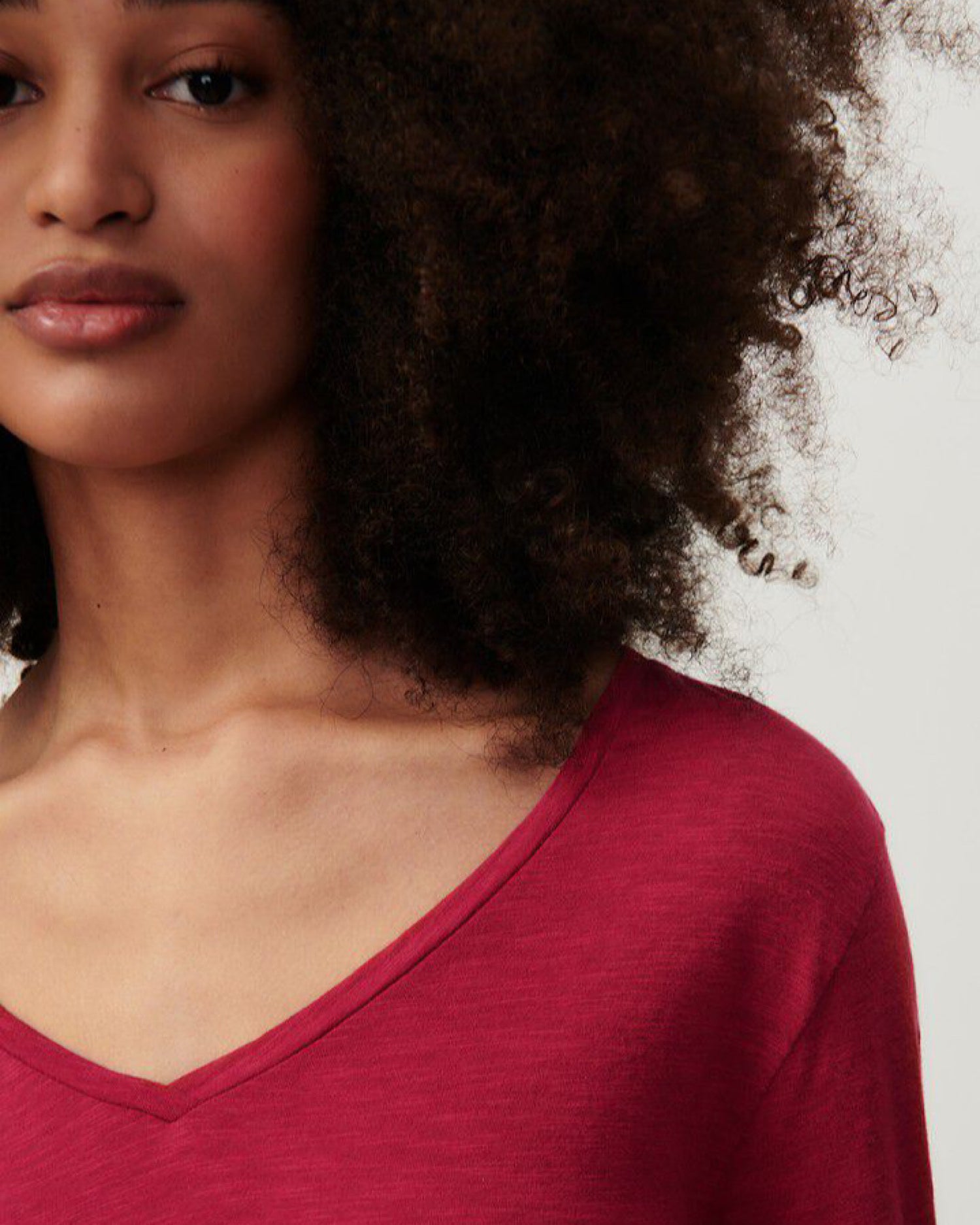 model wearsA V neck long sleeve raspberry red t-shirt