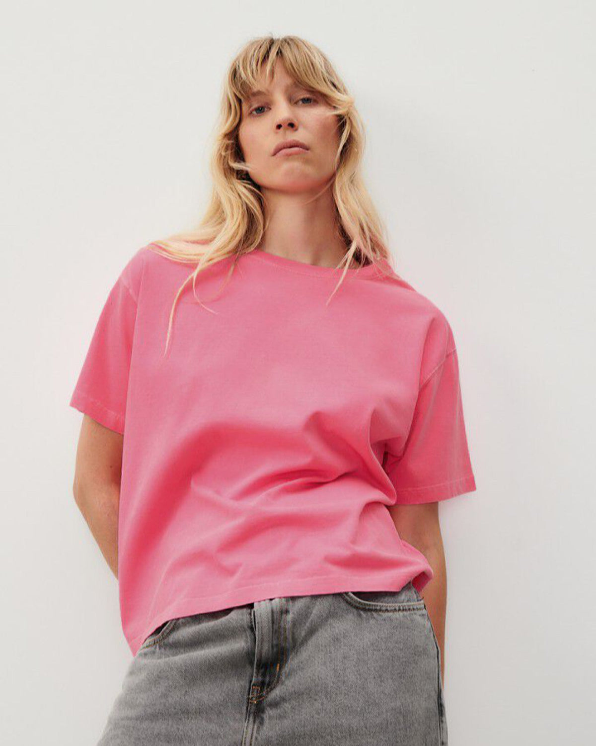 a fluro pink boxy t-shirt on a model