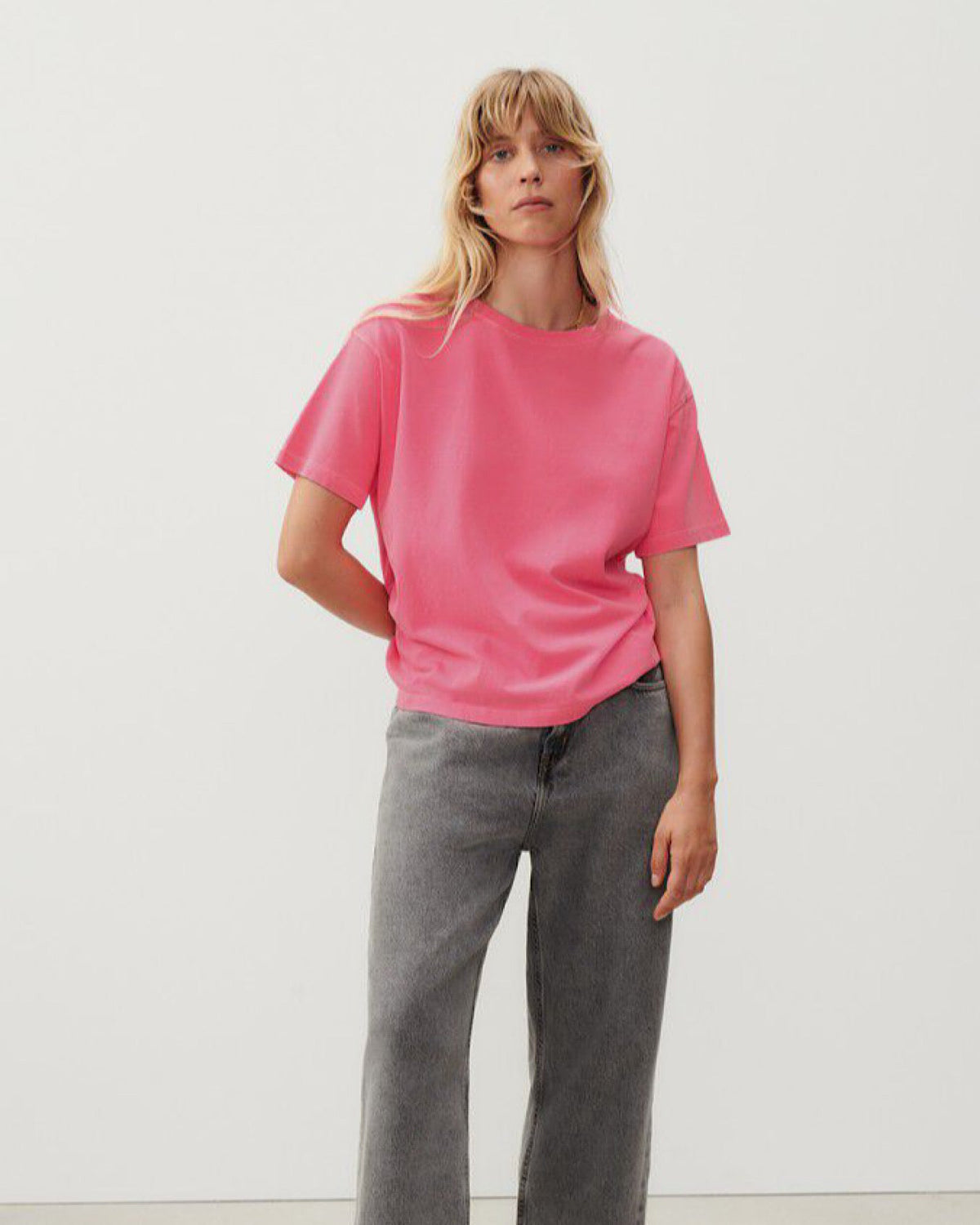 a fluro pink boxy t-shirt on a model