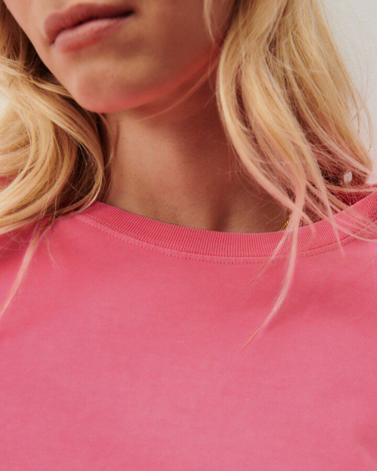 a fluro pink boxy t-shirt on a model