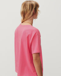 a fluro pink boxy t-shirt on a model