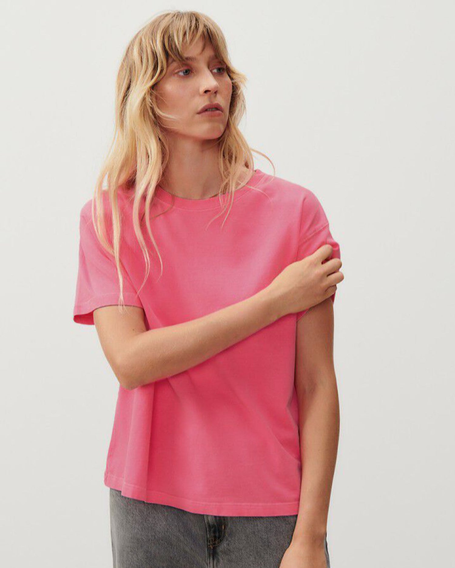 a fluro pink boxy t-shirt on a model