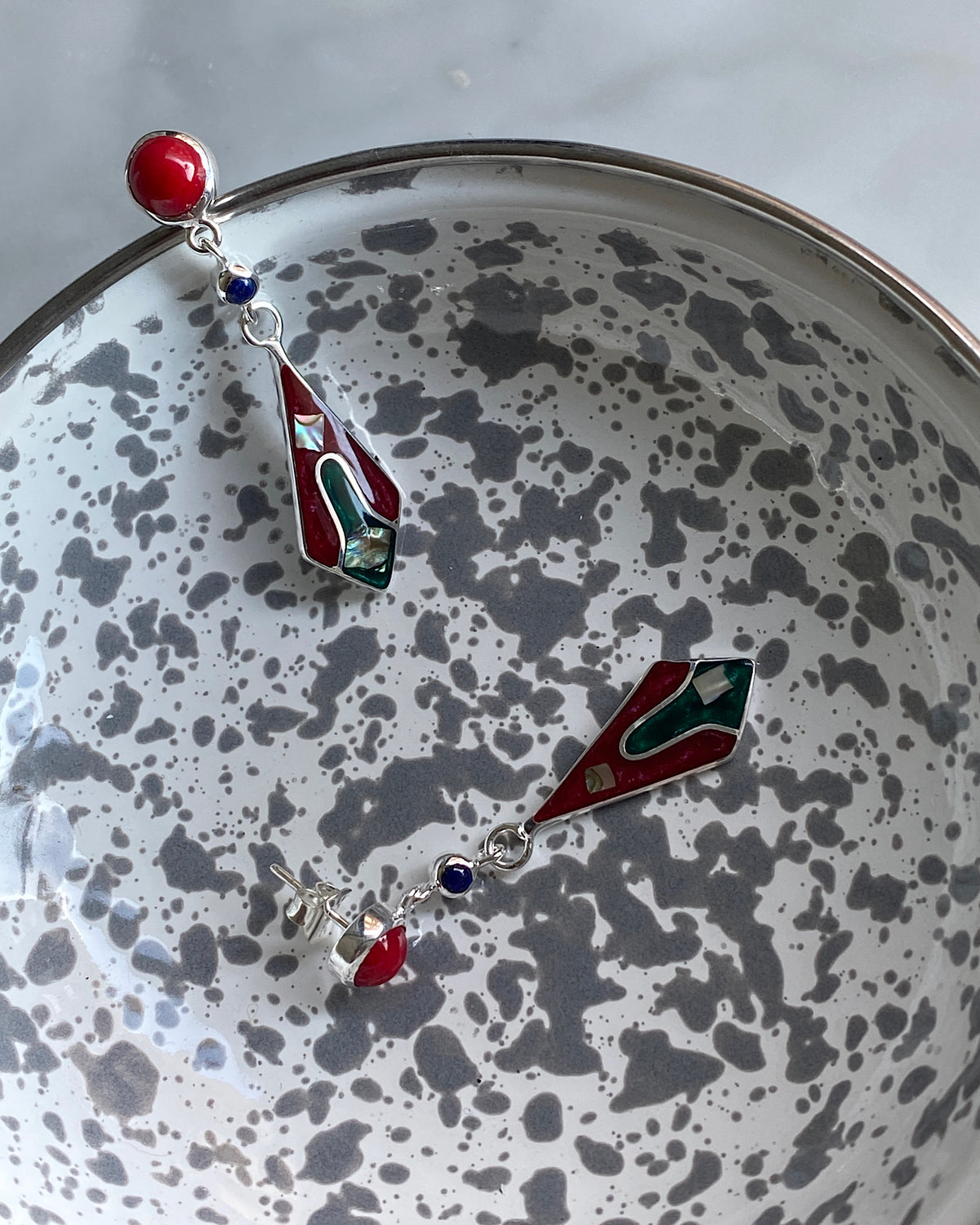 Red stud drop earrings featuring a upside down kite shaped charm with abalone and inlaid