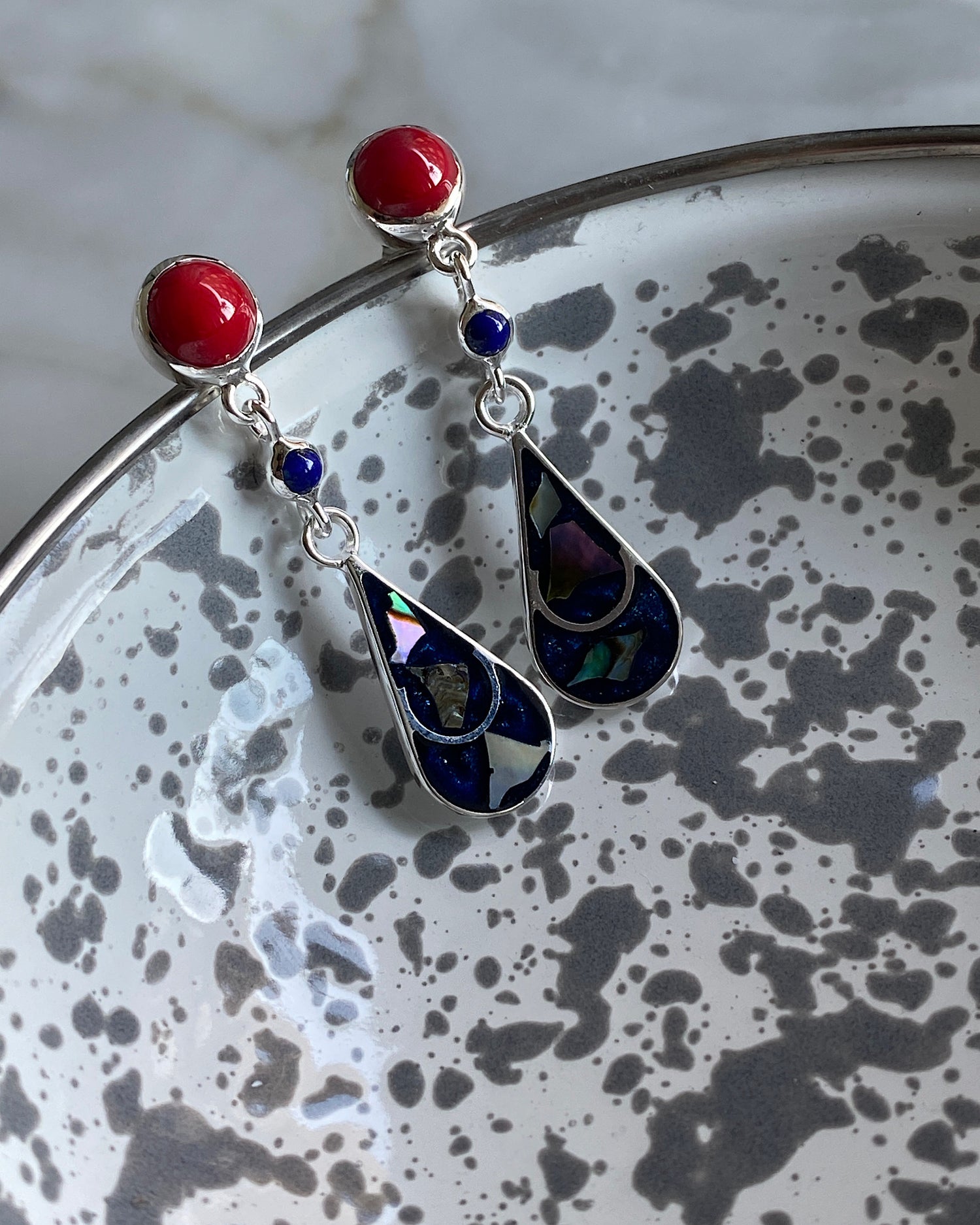 Silver & Coral stud earrings with a blue and blue tear charm hanging of them