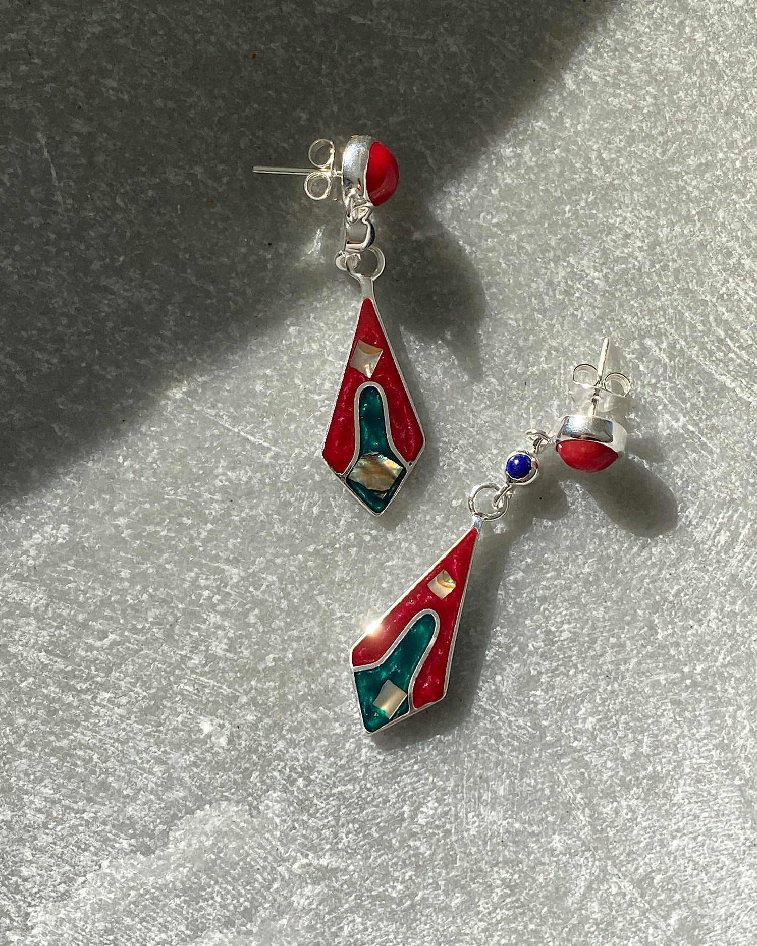 Red stud drop earrings featuring a upside down kite shaped charm with abalone and inlaid