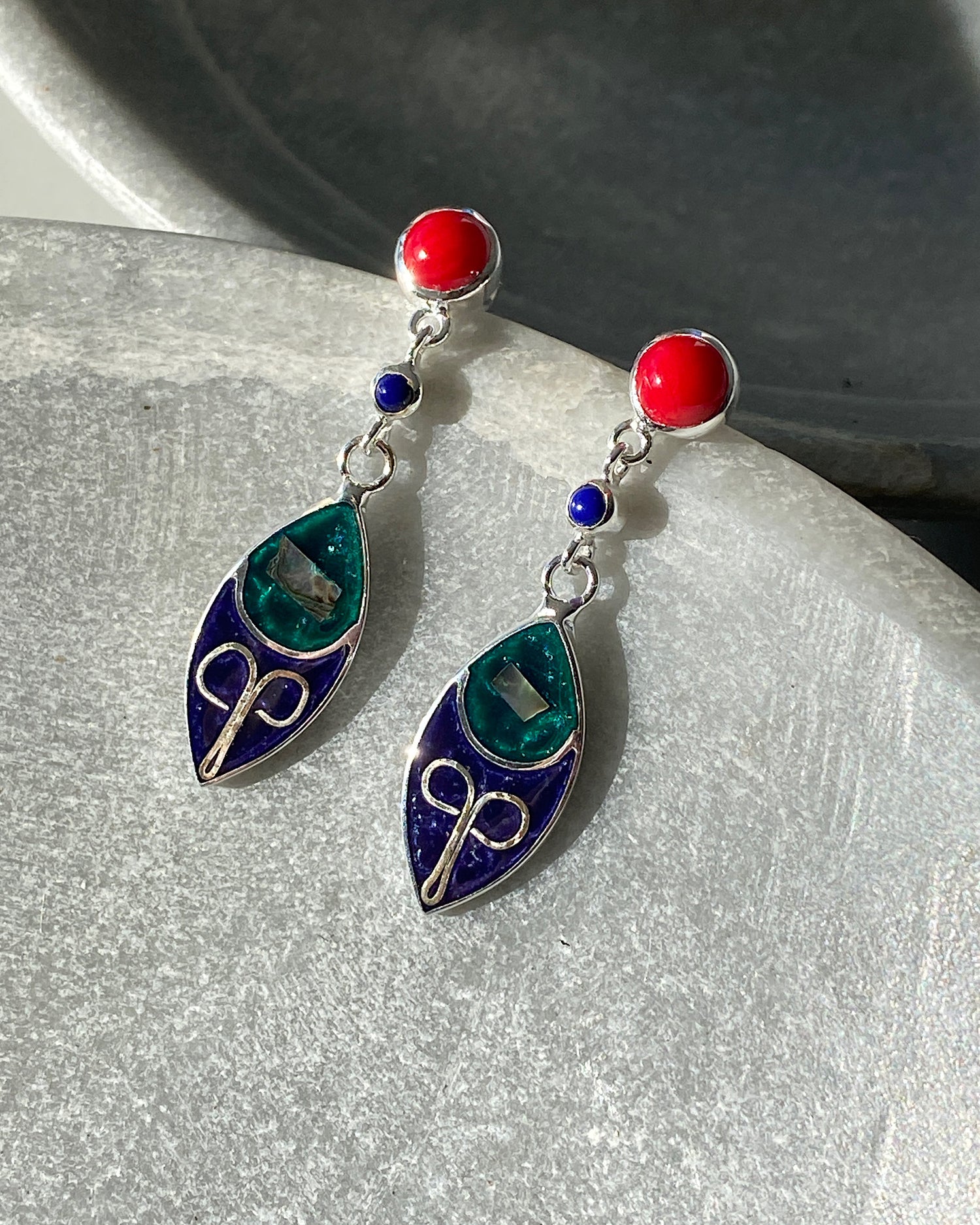 Silver & Coral stud earrings with a blue and green petal charm hanging of them