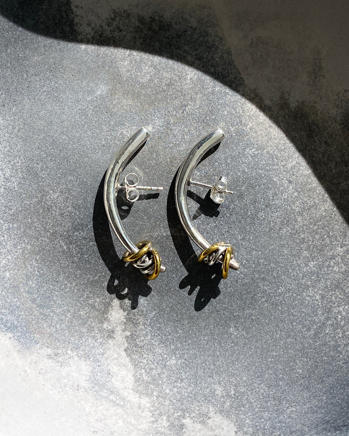 Silver bar curved earrings with mixed metal ring detail