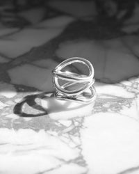 A silver ring made up of a several curved rings joined