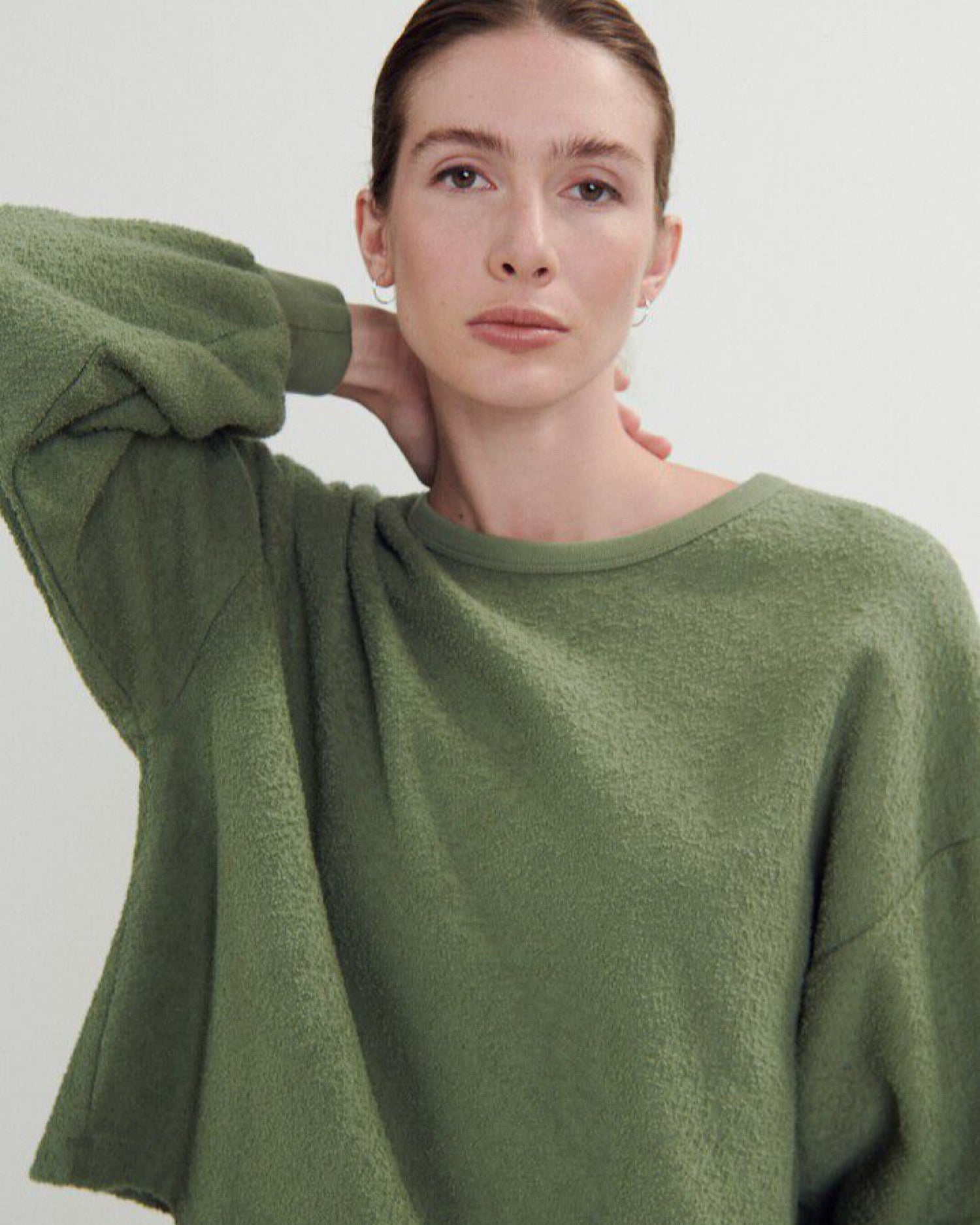 a green boucle style sweatshirt on a model