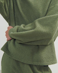 a green boucle style sweatshirt and pants on a model