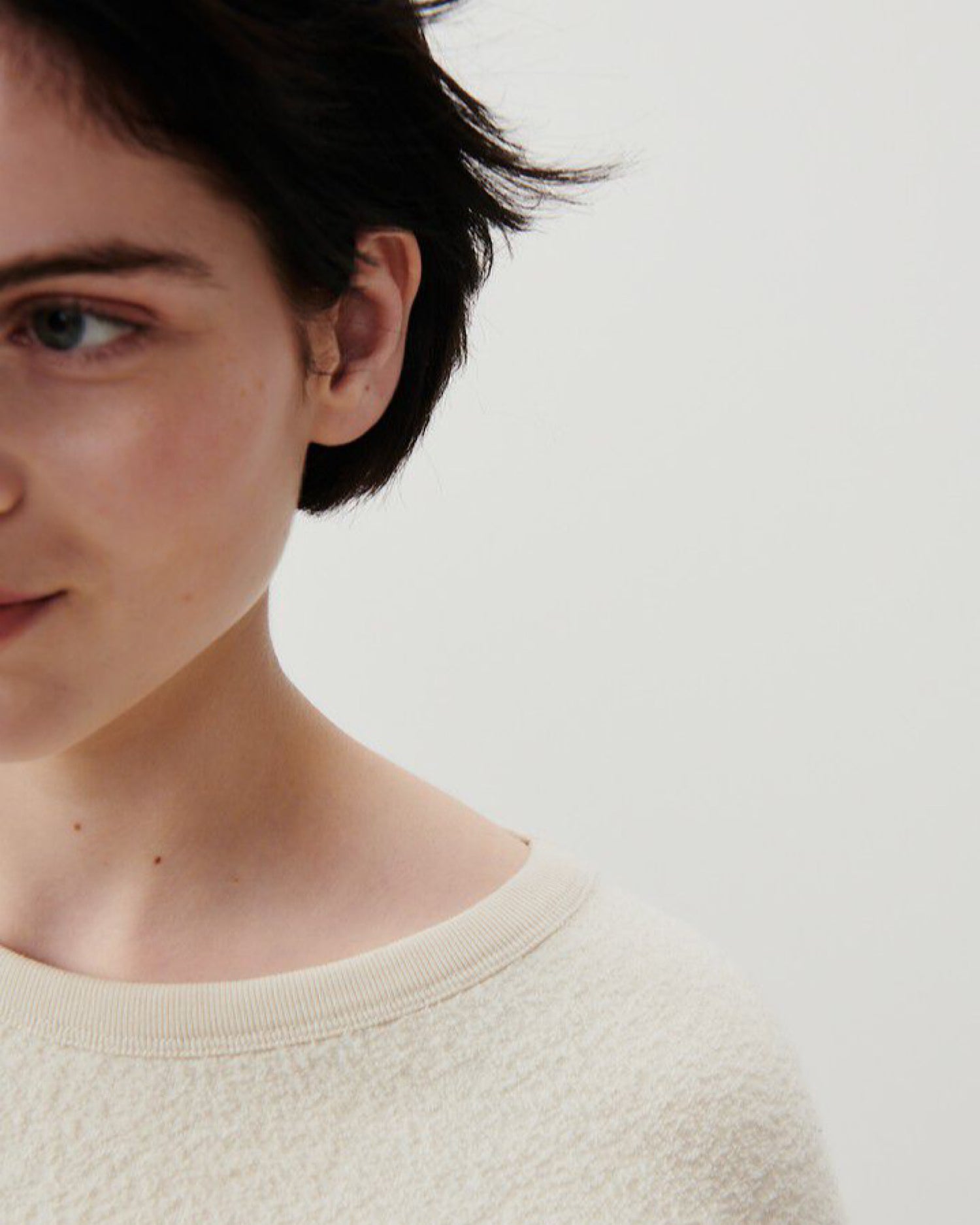 closeup of model wearing a cream boucle style sweater