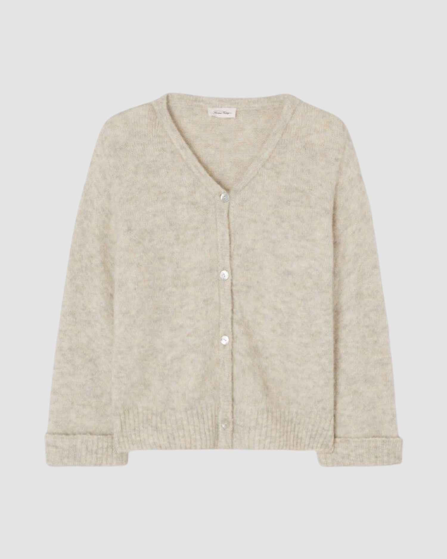 a cream grey cardigan with a v neck and shell buttons