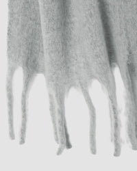 a pale grey scarf closeup showing fringing