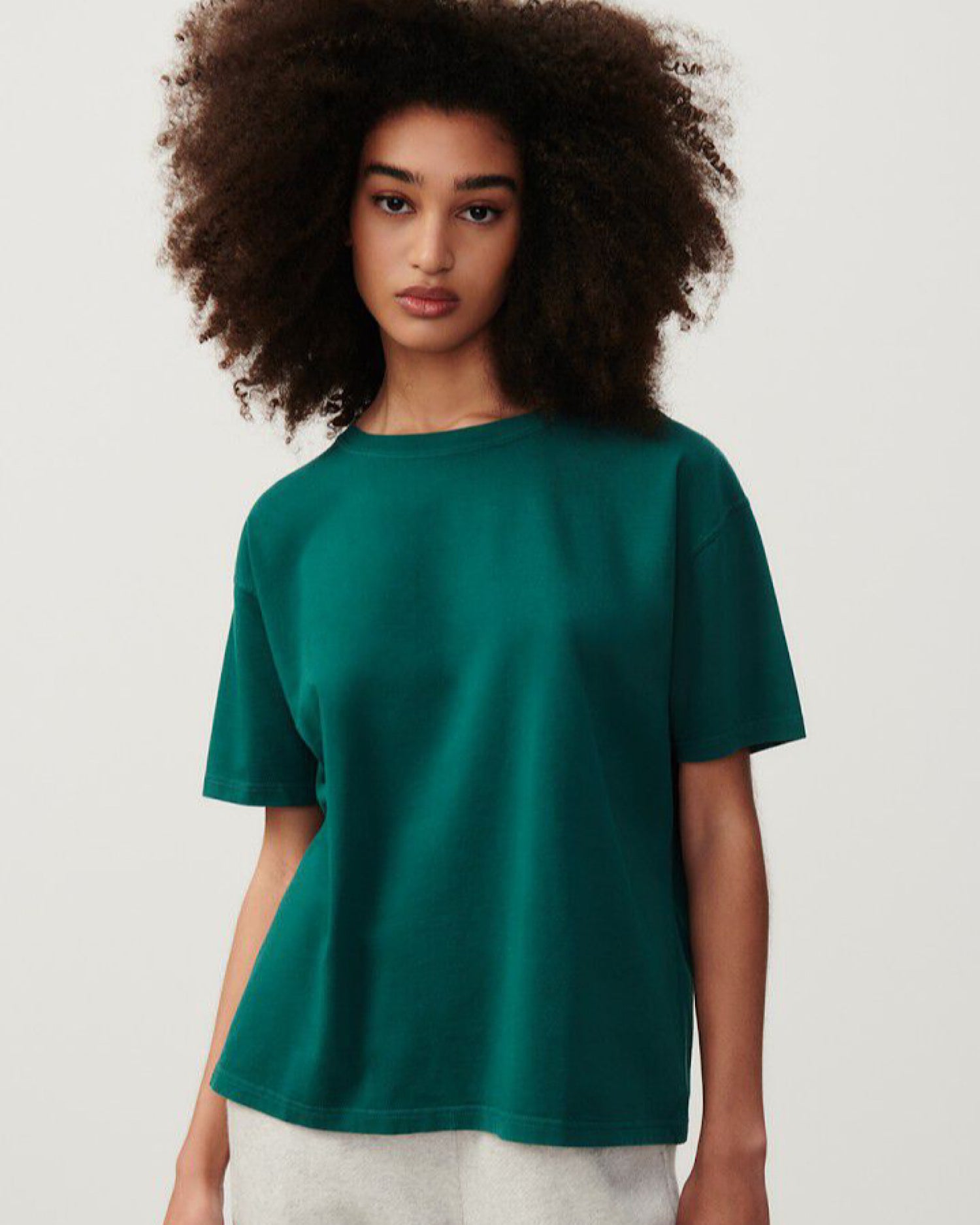 A dark green boxy short sleeve thick cotton dark green t-shirt on a model