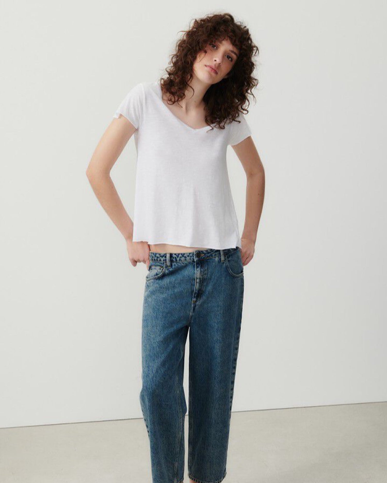 a model wears a white v short sleeve tshirt