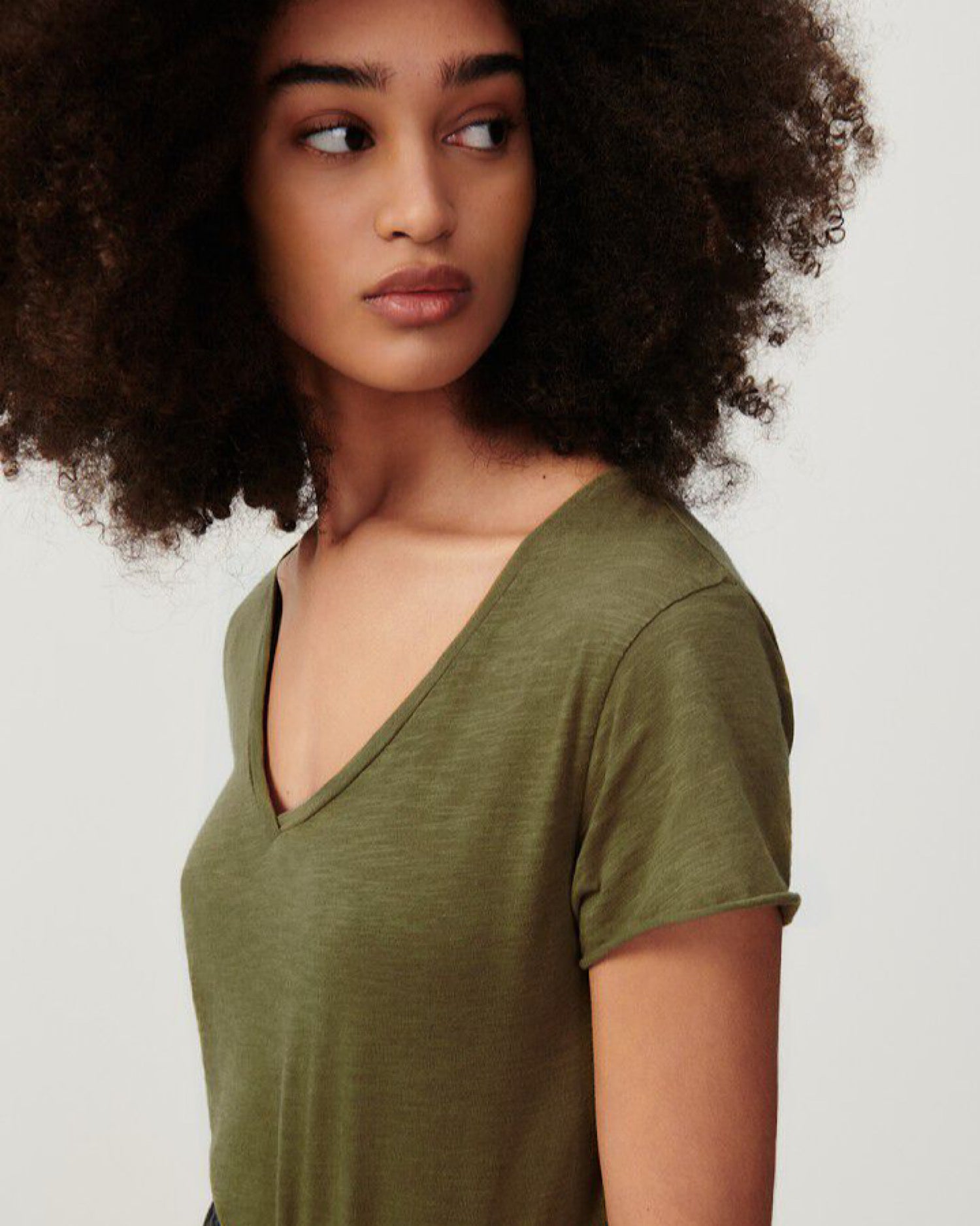 an olive green v neck slub t-shirt on a model