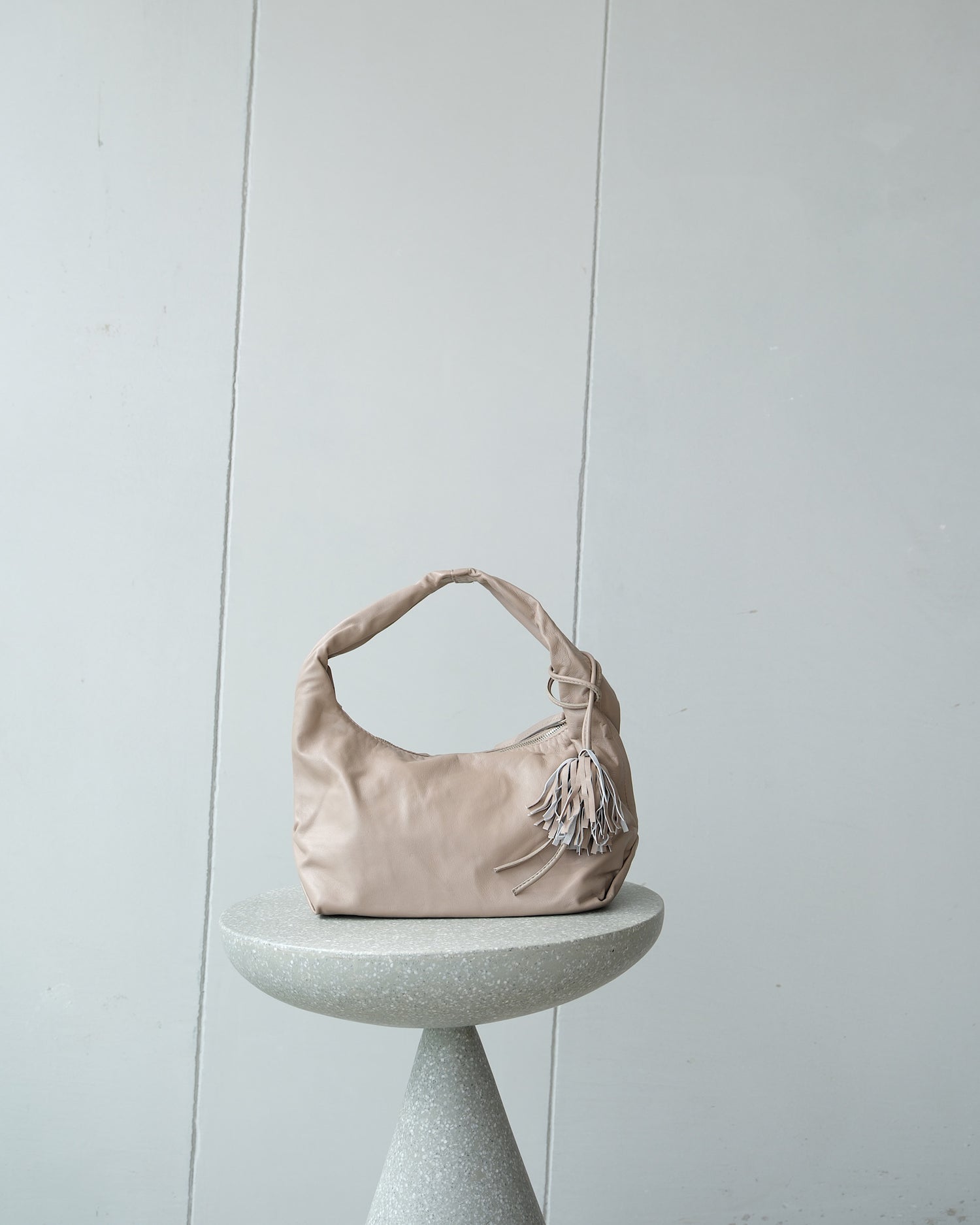 a taupe bag sits on a stool