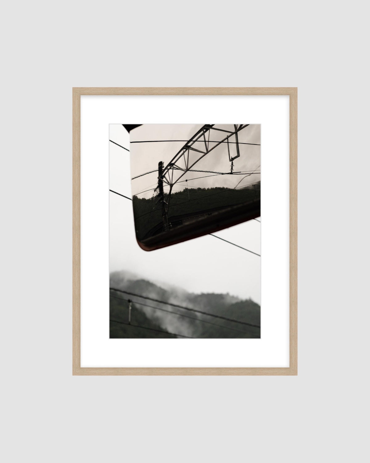 Framed landscape photograph of a mountainscape against a light gray background